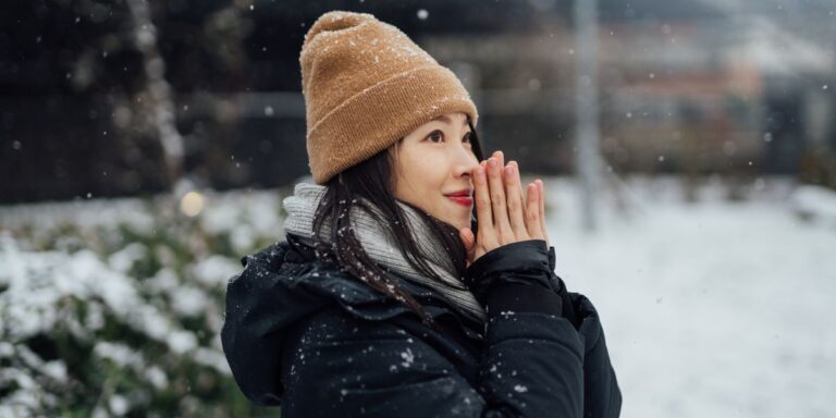 portrait-of-young-woman-enjoying-snow-in-the-city.jpg